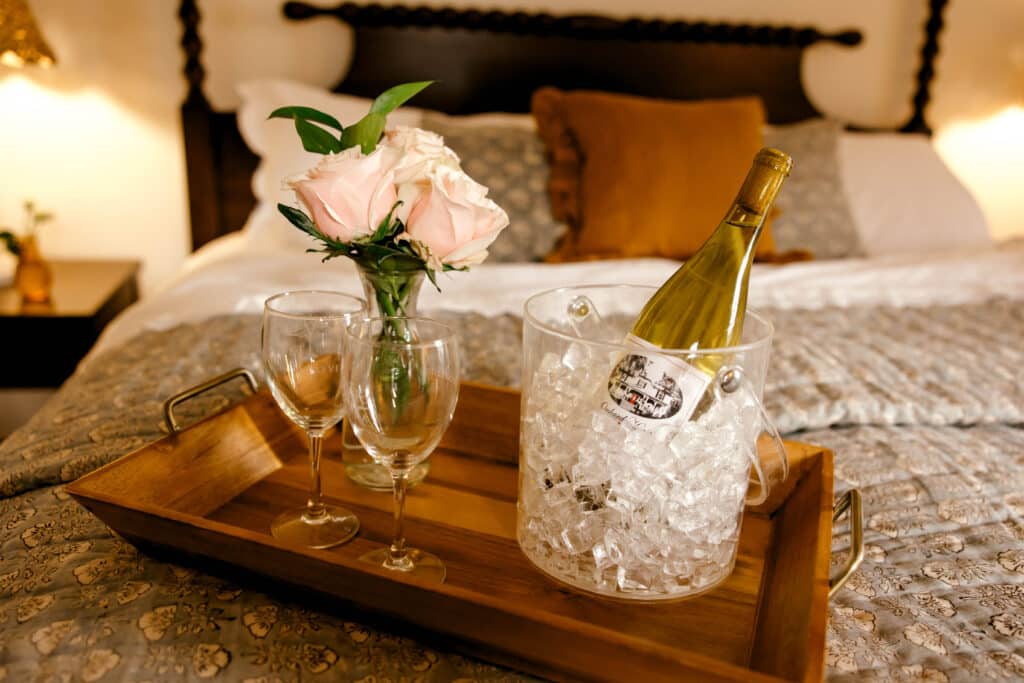Wine and roses on bed at our Bed and Breakfast near Charlottesville