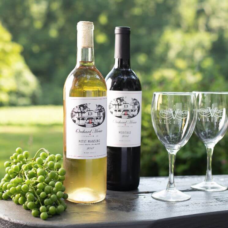 White and Red bottles of wine with grapes and two wine glasses
