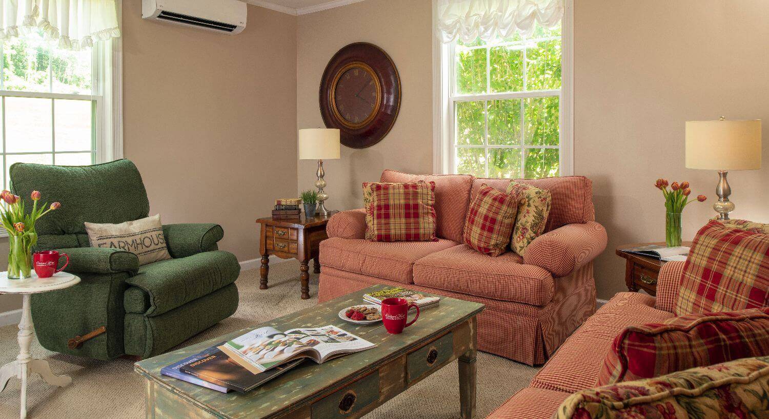 Inviting living room space with comfy couches and large windows. 